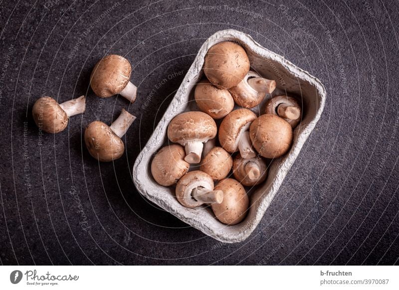 Brown mushrooms in cardboard tray Button mushroom Kitchen Table disk worktop Cardboard shell Packaging Food Mushroom Organic produce Vegetarian diet Delicious