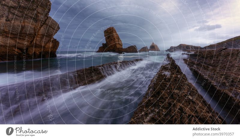 Rocky coastline in stormy weather sea rock wave dramatic dark rough rocky landscape ocean spain cantabria playa de la arnia beach nature seascape shore seaside