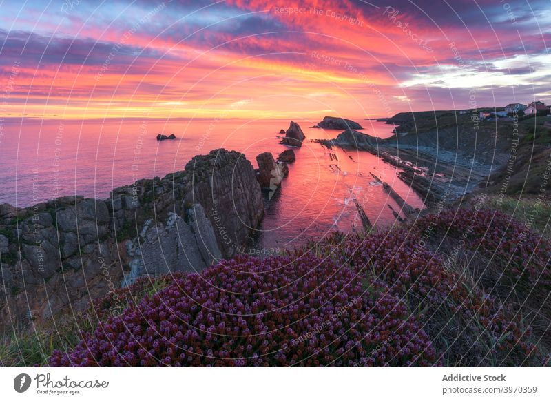 Scenic colorful sunset over rocky coastline sea picturesque shore evening sundown scenery cloudy calm summer spain valdovino coruna galicia nature ocean travel