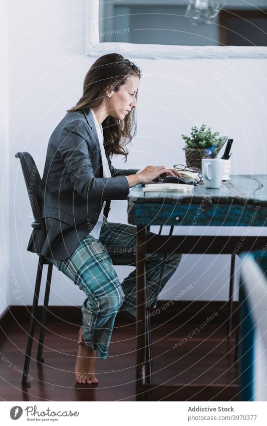 Pensive woman working on laptop at home remote using online freelance young female formal lifestyle device gadget drink browsing internet read connection