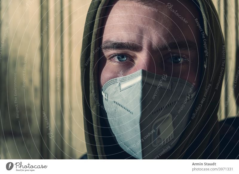 portrait of a young man with a FFP3 corona mask ffp3 protection pandemic pollution virus health care disease infection protective corona virus toxic caucasian