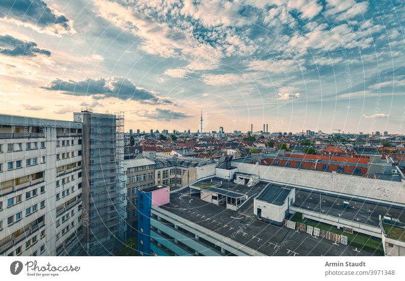 panorama of berlin in the sunset from a kreuzberg backyard Berlin Kreuzberg sea of houses dramatic sky landscape urban city town skyscraper wide far