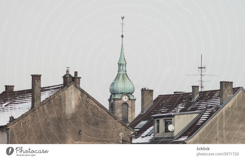 The church of notre Dame de la chapelle in Freyming-Merlebach Lorraine stands out between the roofs of two residential buildings Church France