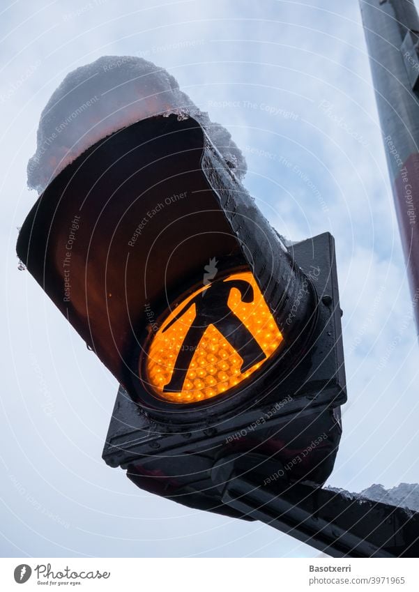 Snowy yellow flashing light with traffic light man at pedestrian crossing Traffic light Yellow Flash signal Footpath Pedestrian nobody Deserted Close-up