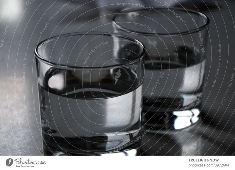 Two sober glasses filled with clear drinking water mirror and reflect almost colorless some daylight Water Drinking water Glasses Tumbler chill colourless Food