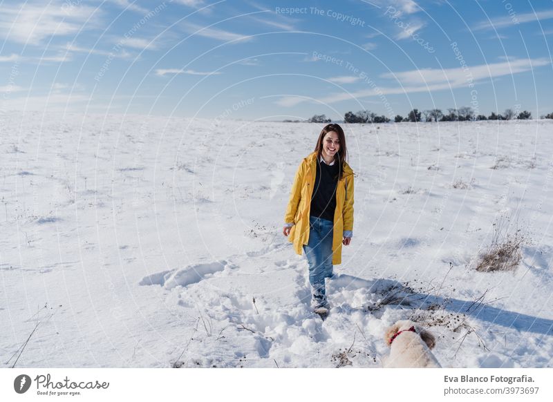 happy woman hiking outdoors in snowy mountain. Nature and lifestyle yellow coat caucasian travel wanderlust backpack time out wellness liberty arm nature sun