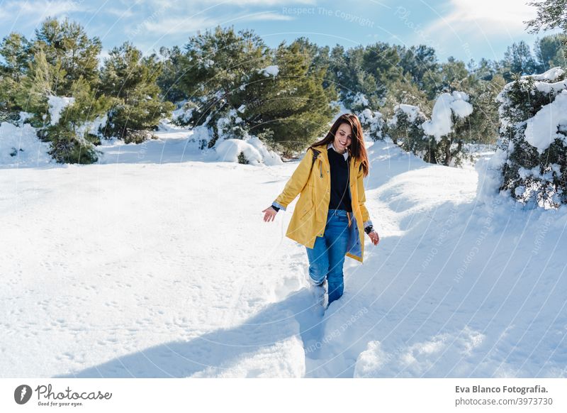 backpacker woman hiking outdoors with cute poodle dog. Snowy mountain in winter season. nature, pets and lifestyle snow yellow coat happy smiling travel daytime