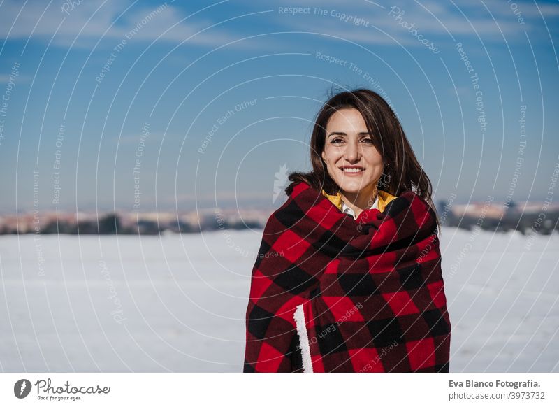 happy woman hiking outdoors in snowy mountain. Wrapped in plaid blanket. Nature and lifestyle wrapped relax caucasian sunny enjoy travel wanderlust backpack