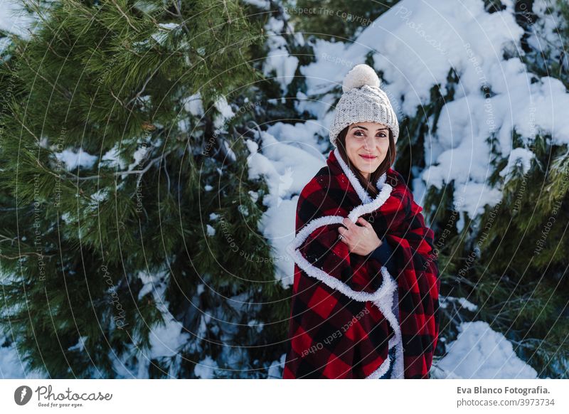 happy woman hiking outdoors in snowy mountain. Wrapped in plaid blanket. Nature and lifestyle wrapped relax caucasian sunny enjoy travel wanderlust backpack