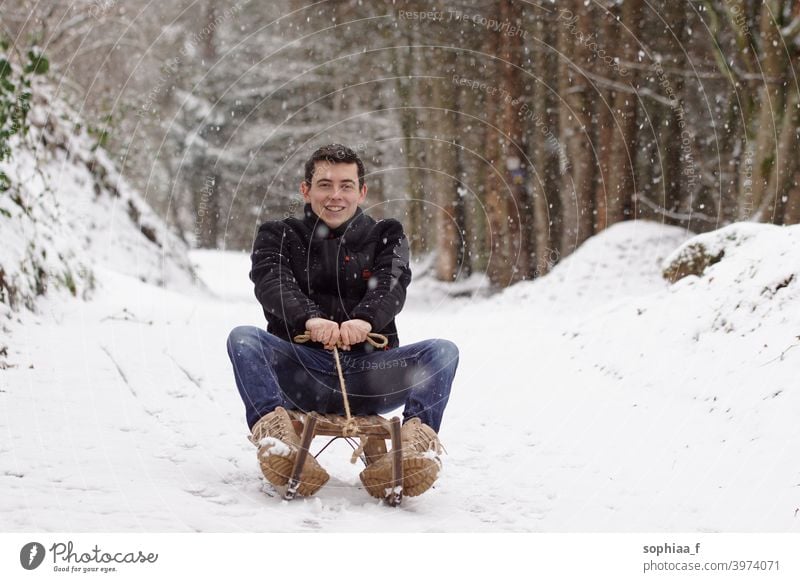 Man riding a sligh, having fun and laughing - Winter time & sledge fun sleigh man snow happiness adult childhood sledding winter happy joy sliding boy downhill