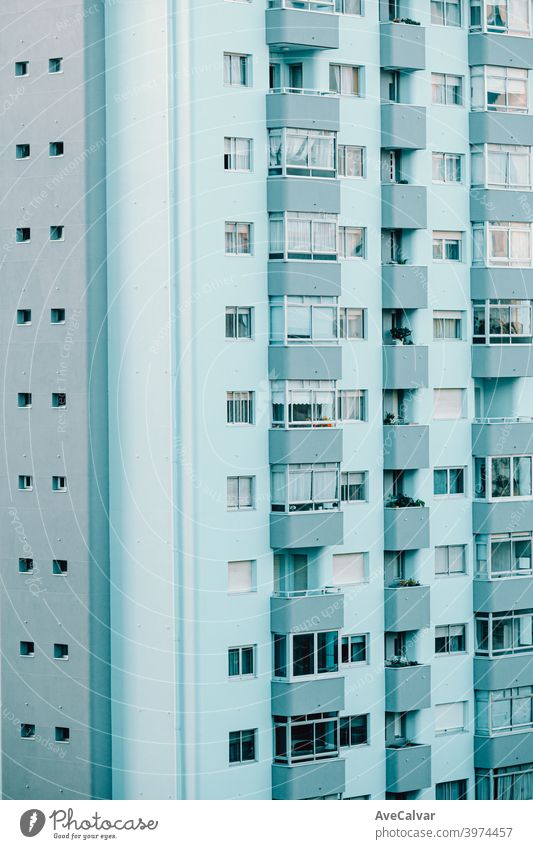 A close up of a repetitive building on blue tones with copy space and cinematic ambient rise property estate future residential tech renewal lines symmetry