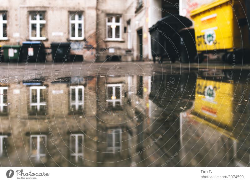 Backyard with puddle Prenzlauer Berg Berlin Old building dustbin Deserted Town Downtown Capital city Old town Day House (Residential Structure) Exterior shot