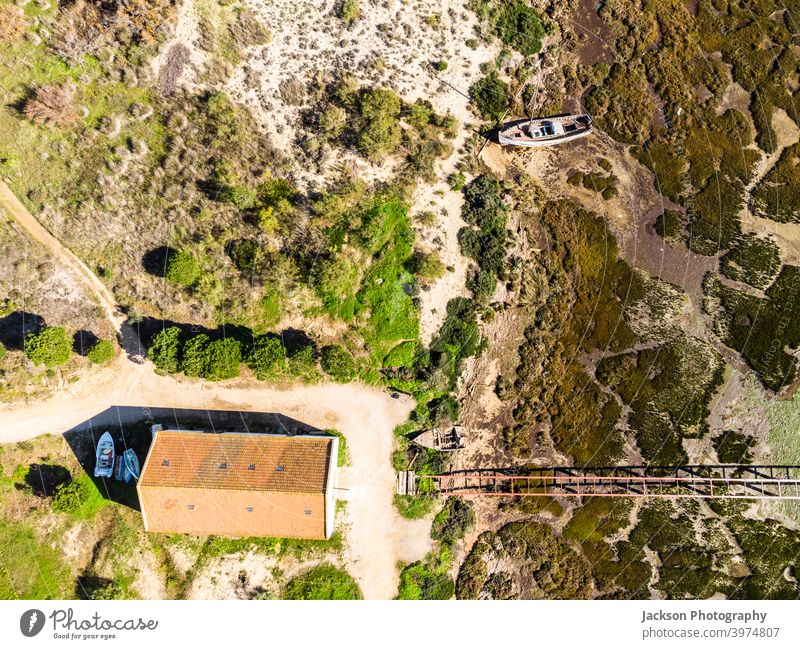 Aerial view of Ria Formosa Natural Park in Olhao, Algarve, Portugal portugal wetlands park ria formosa olhão olhao above drone aerial pier house boat coastal