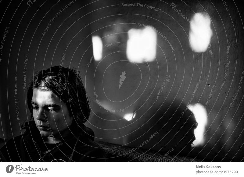 boy in the room with sunrays through window man face shadow serious faceportrait contrast male handsome guy style Black and white photography black and white