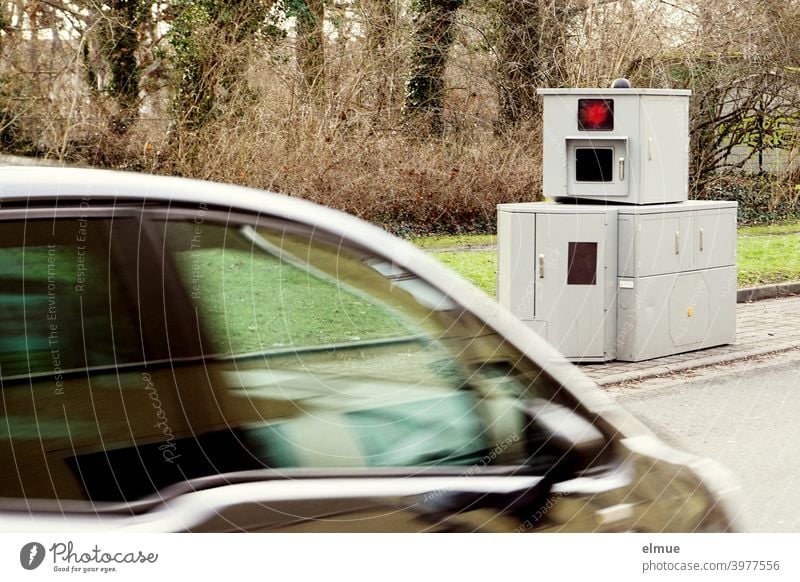 Partial view of a fast passing car in front of a flash unit / speed control Tank Flasher speed cameras Traffic monitoring Speed control Road traffic swift