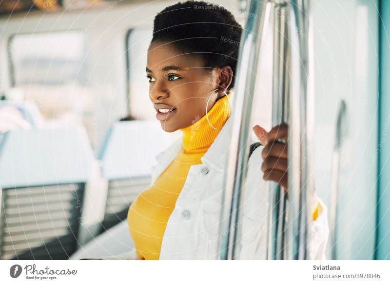 Portrait of a young African woman who rides the subway metro african standing train smiling inside portrait passenger urban black women black millennials