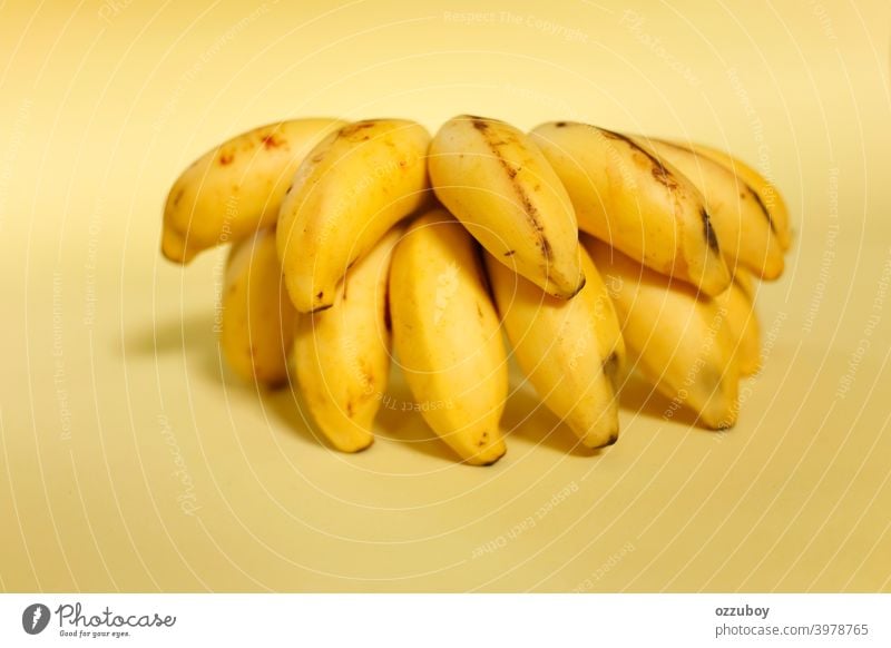 bunch of banana isolated on yellow background fruit snack food ripe healthy tropical closeup fresh diet organic freshness sweet group horizontal skin color