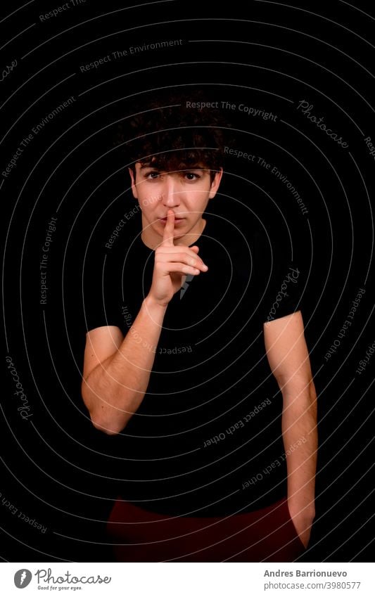 Attractive young man with curly hair posing on black studio background caucasian closeup thoughtful guy looking people short attractive beauty haircut fashion