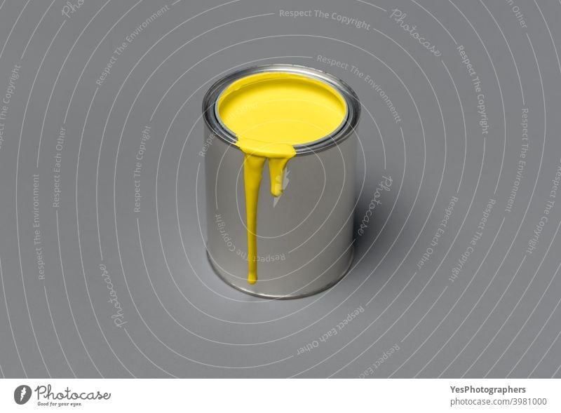 Yellow paint can on gray background. Tin can with  yellow paint, 2021 trend color 13-0647 17-5104 acrylic blank chalky paint color scheme colors container