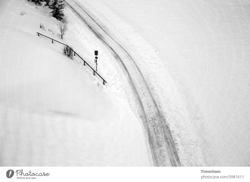 Paths and trails in the snow Snow Winter Cold Frozen Lanes & trails Nature footprints vehicle tracks Snow layer shrubby Signage Black & white photo