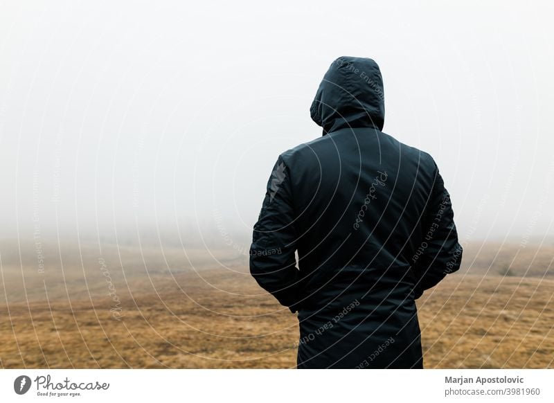 Young man exploring nature on a wet winter morning in the mountains adventure alone autumn beautiful challenge cold europe exploration explore explorer fog