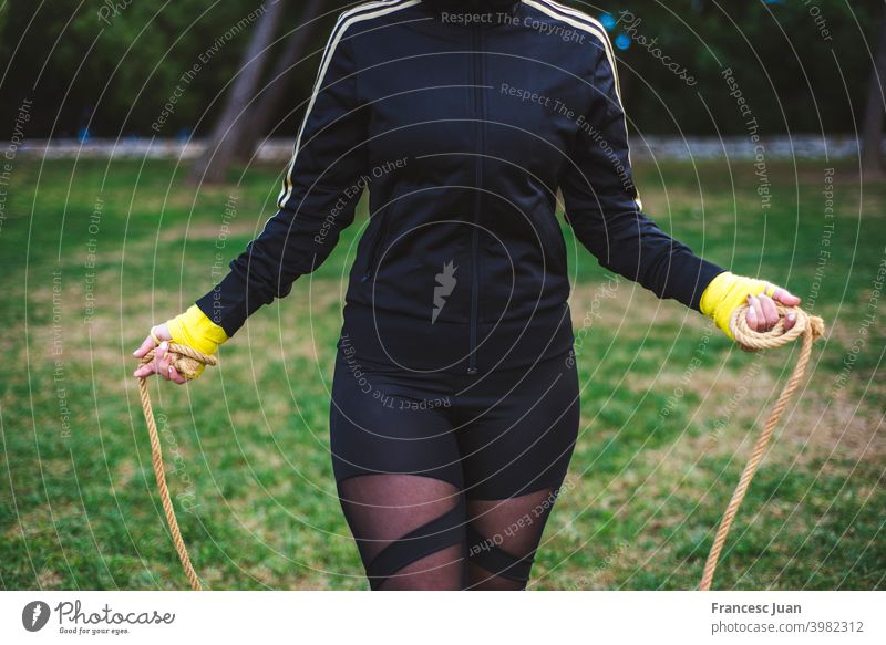 Outdoor shot of determined woman skipping outdoors in nature. beautiful exercise fitness girl happy healthy park training wellness active athlete athletic