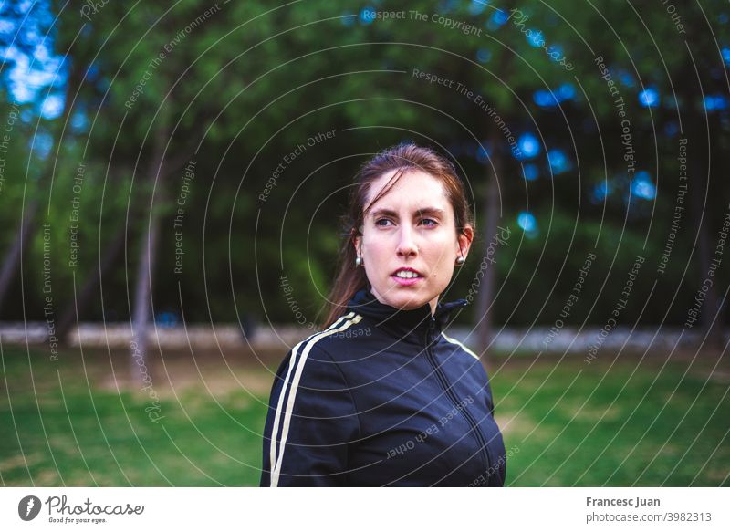 Outdoor portrait of serious girl about 30 years old at park, close-up. lifestyle caucasian female hair lady person people outdoor one looking selective focus