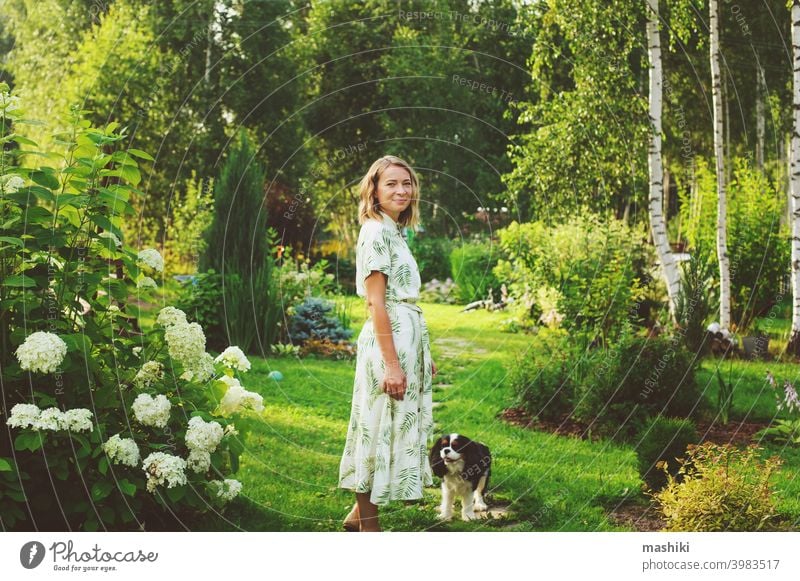 beautiful young woman gardener posing with hydrangea flowers in summer cottage garden person gardening outdoor plant female lifestyle nature adult girl smiling