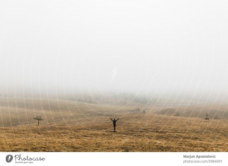 Young man exploring nature on a wet winter morning in the mountains adventure alone autumn beautiful challenge cold europe exploration explore explorer fog