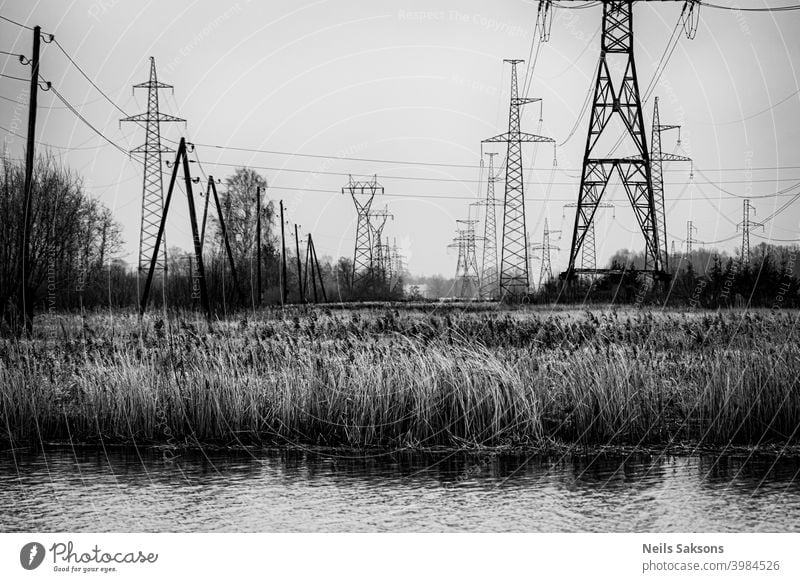 high voltage power lines towers over the river Background blue building cable coastline construction danger day distribution electric electrical electricity