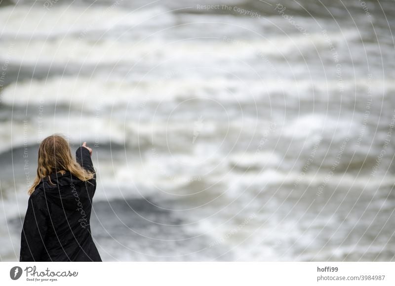 the woman points into the void of the tide, where will it go .... storm tide Climate change uncertainty Ocean Gale Sky Water Environment Wind Flood Weather