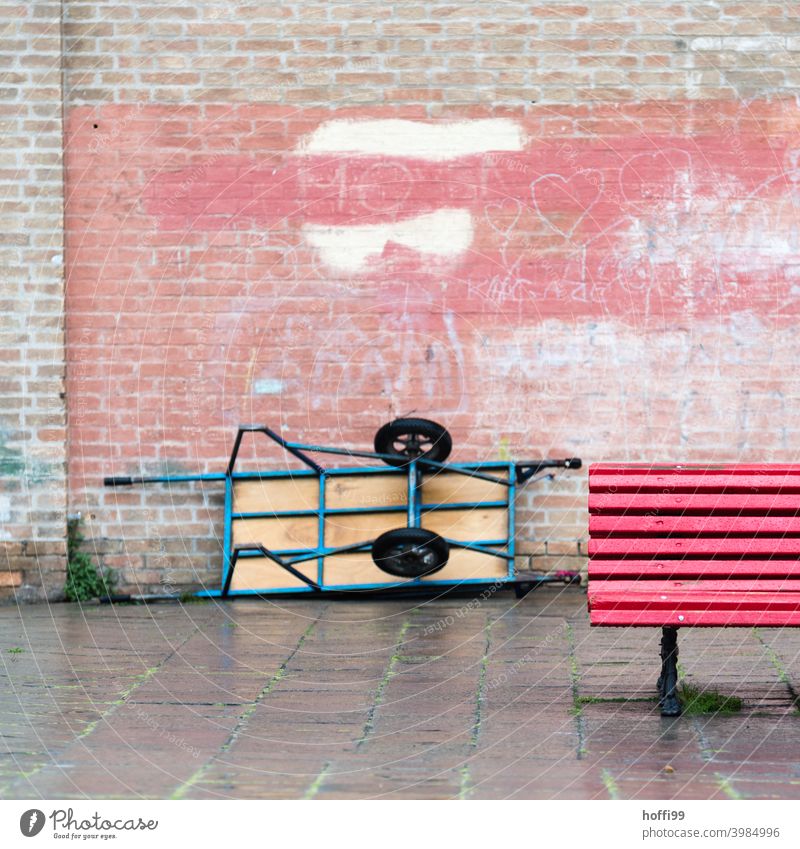 Red bench with delivery cart and old wall in Venice Park bench Brick wall Break Wheelbarrow Bench Wood Delivery carts Delivery truck Cart Seating Relaxation