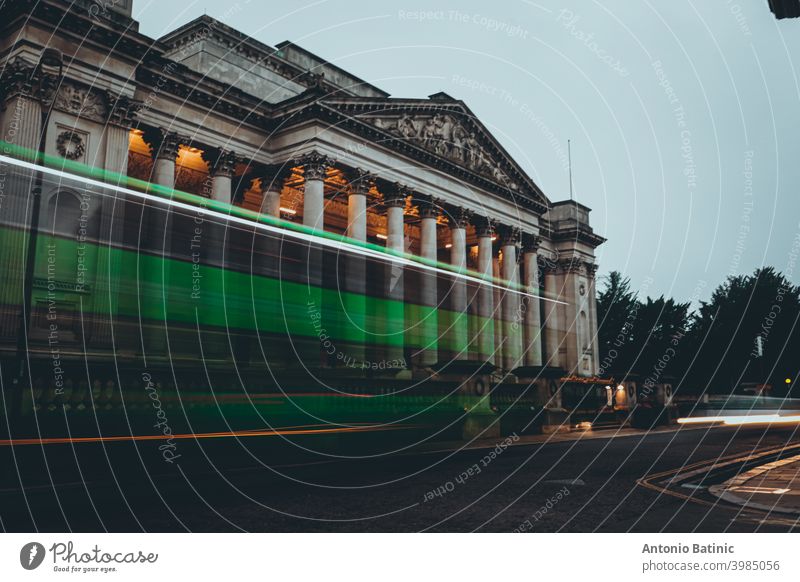 Long exposure of a green bus passing in front of the arhitecture museum in cambridge city public nightlife tail transport sunset time evening dusk landmark