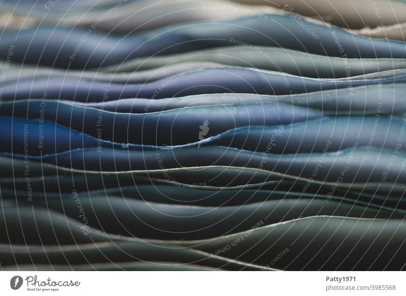 Macro shot of a stack of blue wavy paper Paper crimped Blue macro Close-up Shallow depth of field Stack Undulating edge Detail Structures and shapes background