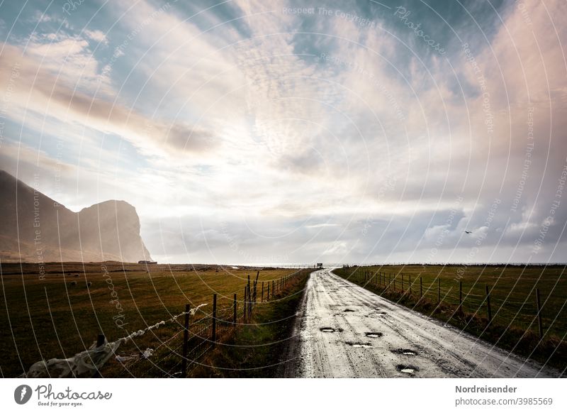 Road to the beach at Unstad on the Lofoten in Norway Lofotes unstad Beach Ocean Camping site Street Rain off the beaten track Rainy weather Evening Light