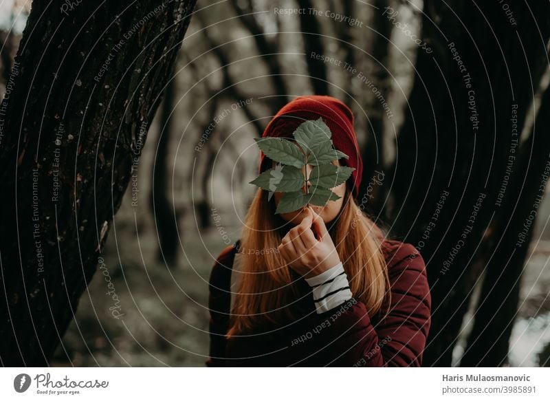 woman holding leaf in nature art flower background beautiful covered face female forest girl green holding plant leaves nature lover outdoor people person