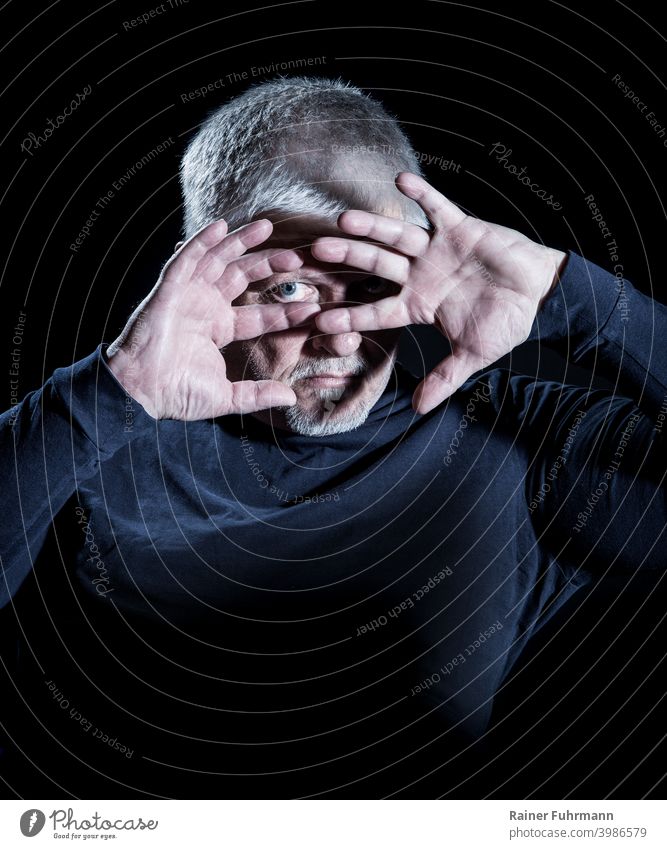 Portrait of a man protecting himself from a bright light with his hands. Light Flashy Protection portrait Human being Shadow Hand Dark Fear Panic Fingers Man