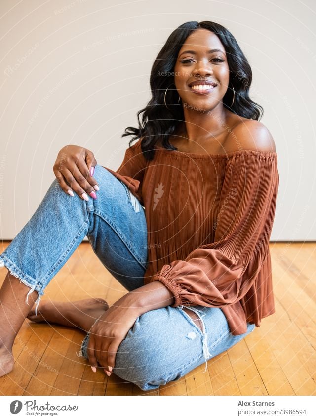 Model Sitting on the Floor Smiling Fashion Black smiling Happy human blogger lifestyle woman Hair and hairstyles Portrait photograph Beautiful pretty Face Style