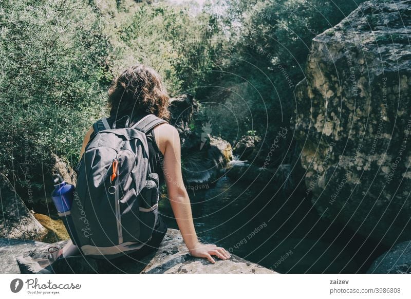 Girl sitting looking at the views of the Prades mountains, Tarragona. la febró prades catalonia spain outdoor medium copy space color people female one person