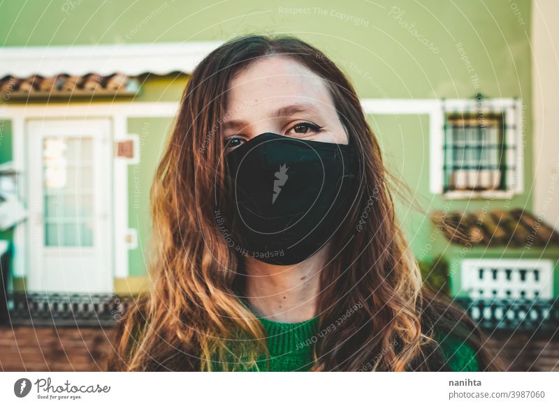 Image of a woman in red with a black face mask pandemic pandemia covid coronavirus green contagious influenza common cold infectius infective new normality