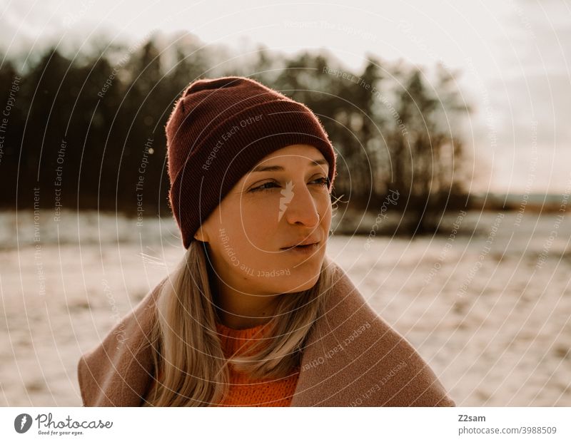 Portrait of a fashionably dressed woman in winter landscape Winter wonderland Woman Young woman Coat To go for a walk Snow Sun Light Nature Landscape Scarf Cap