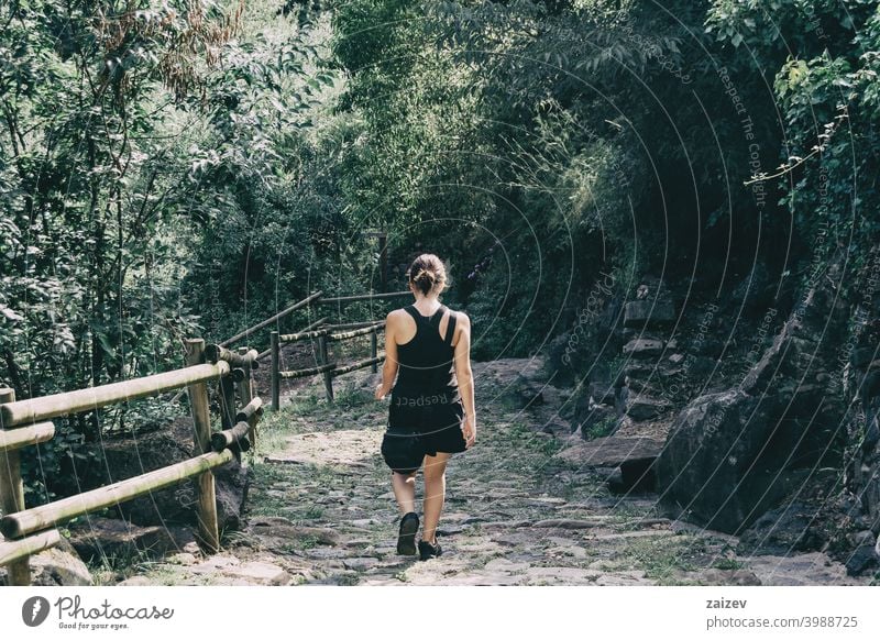 Girl walking along a small path in the mountain of sadernes, Spain. spain outdoor medium copy space color people female one person 20s 30s top left right