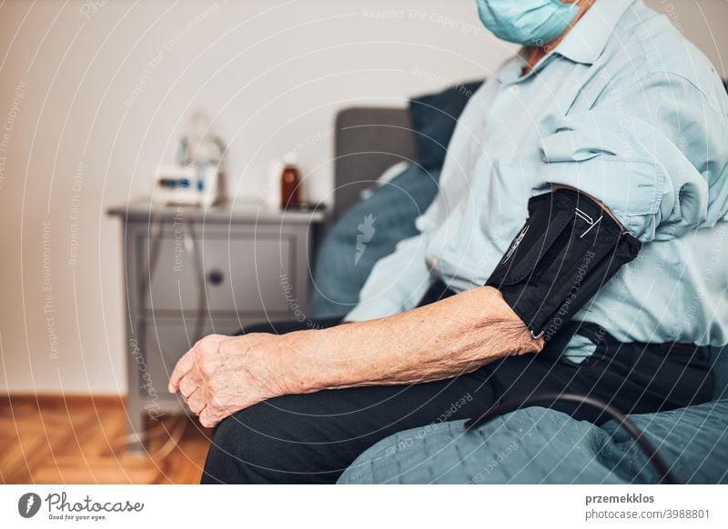 Senior man measuring blood pressure and heart rate himself. Checking health condition elder patient suffering from arterial hypertension test check medical care