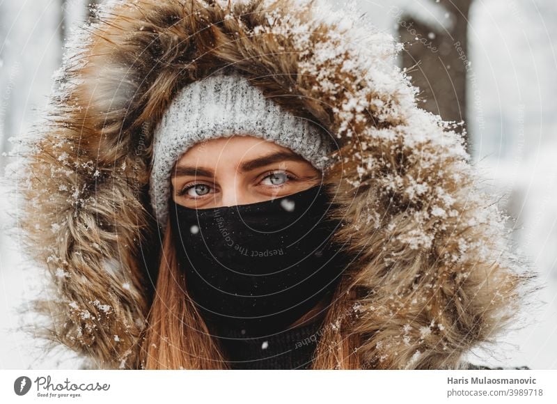 Beautiful woman with facial mask outdoors in snow attractive beautiful beauty caucasian close up cold cute enjoy snow enjoy winter eyes face face mask fashion