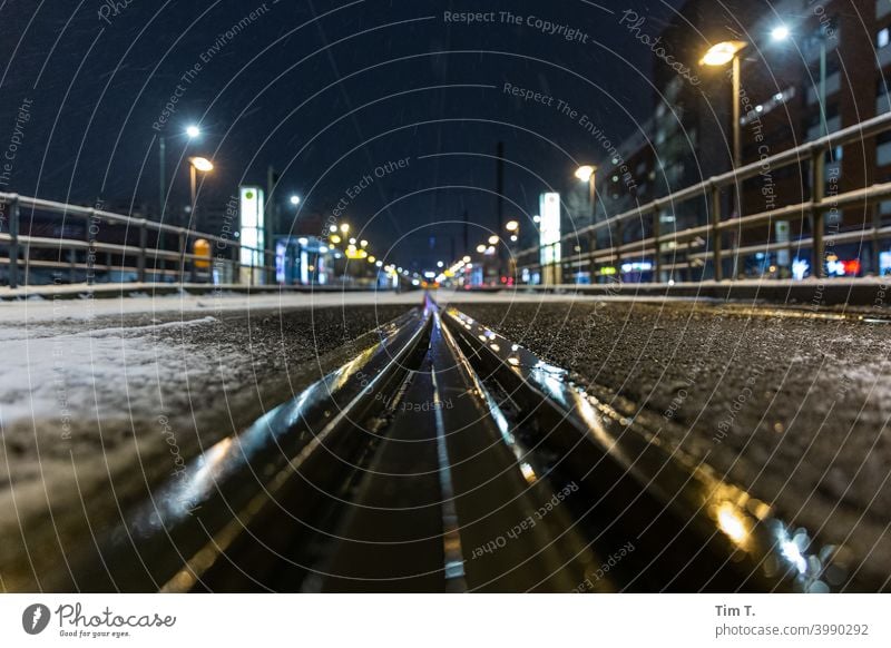 Wet tracks at the Landsberger Allee stop in winter Friedrichshain Berlin Night Stop (public transport) Station Winter snow Snow Railroad tracks Reflection