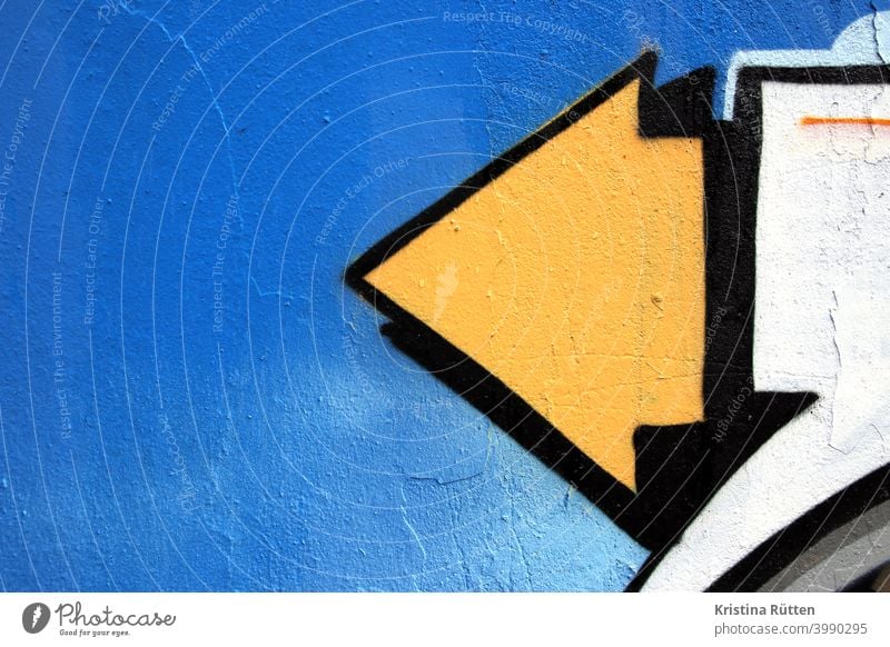 yellow arrow and blue background, graffiti Arrow Direction Blue Yellow Sky sunny sprayed Graffiti off Road marking Orientation Sign symbol Target ensue