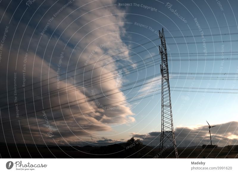 Power pole and wind turbine after a thunderstorm in Gembeck am Twistetal in the district of Waldeck-Frankenberg in Hesse Electricity pylon Overhead line