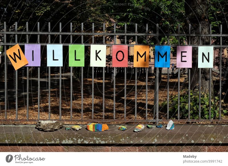 Lettering WELCOME made of black letters on coloured paper on the fence of a school after the summer holidays in the Nordend district of Frankfurt am Main in the German state of Hesse