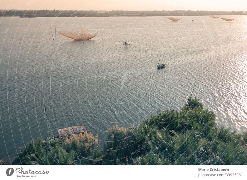 Aerial view of the iconic stationary lift nets fish trap in Cua Dai Beach in Hoi an, Vietnam aerial view vietnam hoi an sunset vietnamese culture cua dai beach