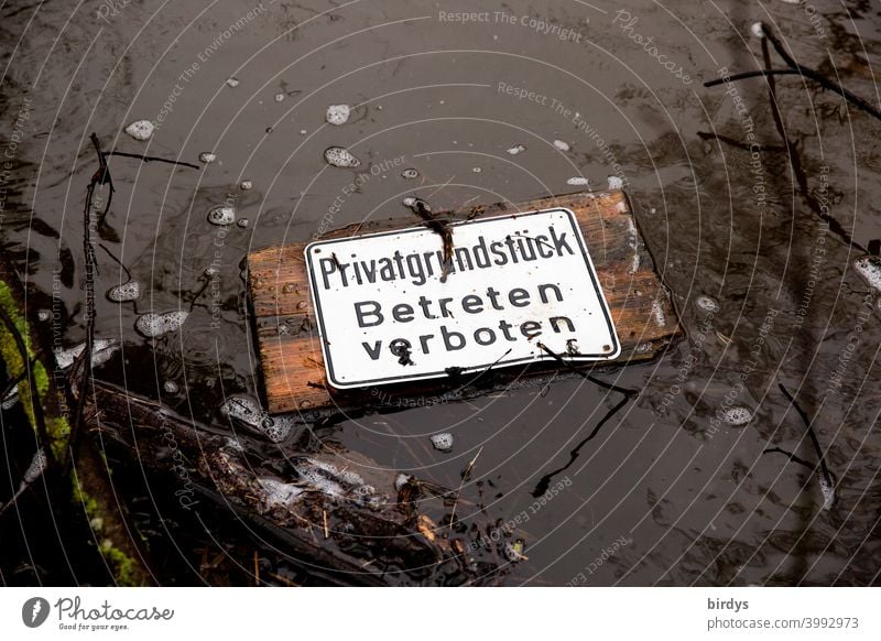 Private property. Do not enter. washed up prohibition sign in a brook. private property no trespassing Signs and labeling Water Brook flotsam Bans Funny bizarre